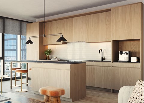 A modern kitchen with wooden cabinets and a bar stool.