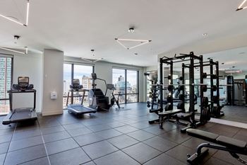a gym with exercise equipment and a view of the city at Platform 4611, Chicago, IL 60640