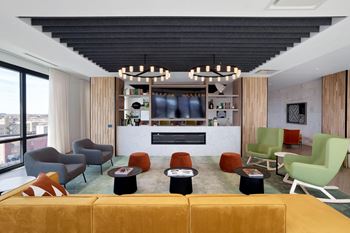 living room with a yellow couch and colorful chairs at Platform 4611, Illinois