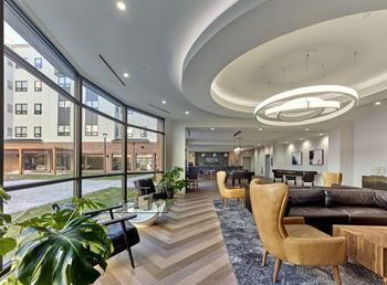 a large room with a large window and a couch and chairs