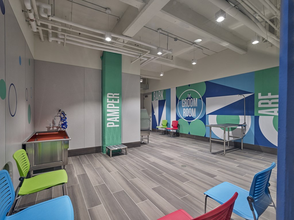 a room with colorful chairs and a table with a pool table
