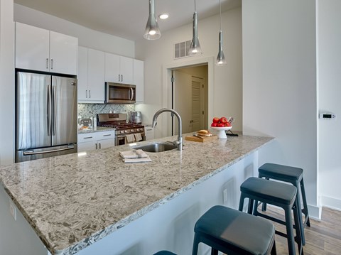 a kitchen with a large granite counter top and a sink