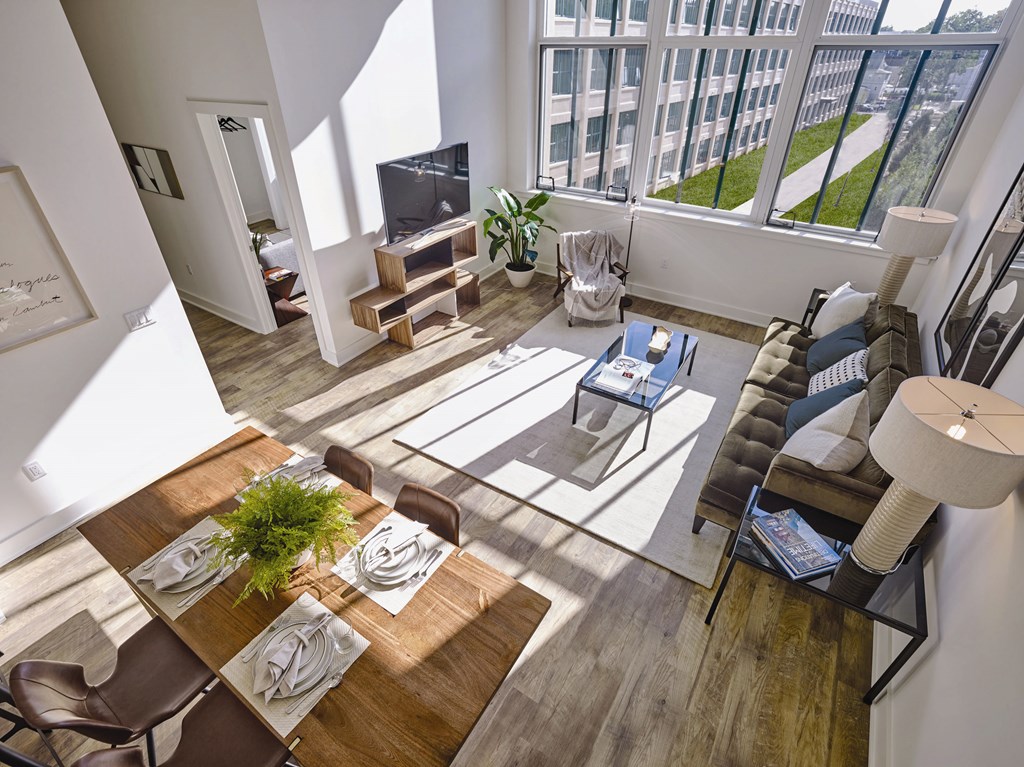 A modern dining room with a wooden table and chairs.