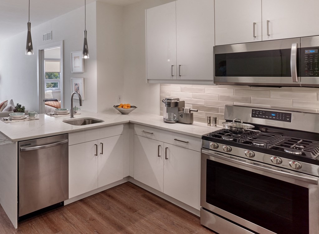 a kitchen with stainless steel appliances and white cabinets