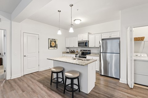 A kitchen with a white counter and a refrigerator.