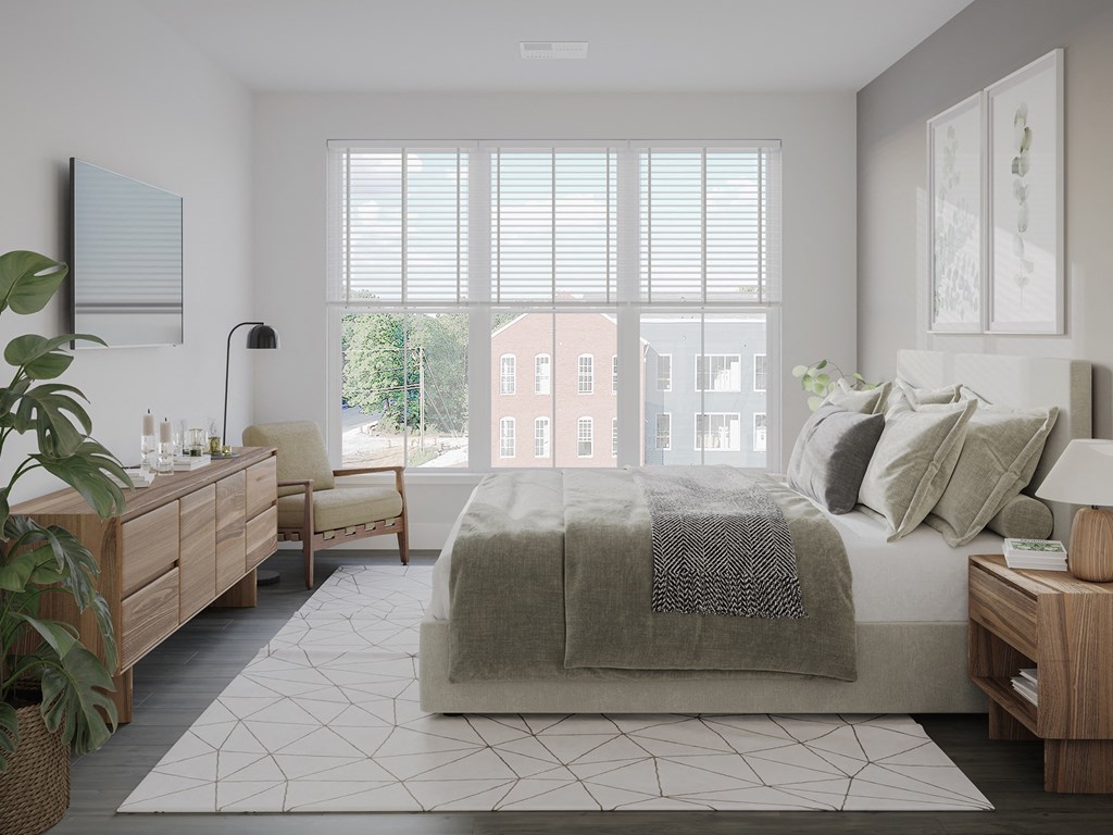 a bedroom with a bed and a large window