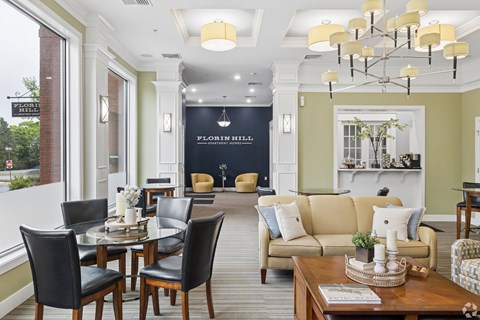 A living room with a dining table and chairs.