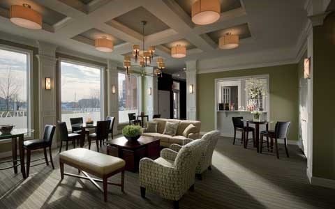 A living room with a couch, chairs, and a table.