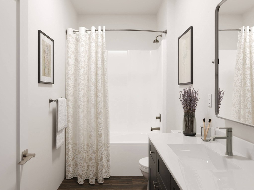a bathroom with a shower and a sink and a mirror