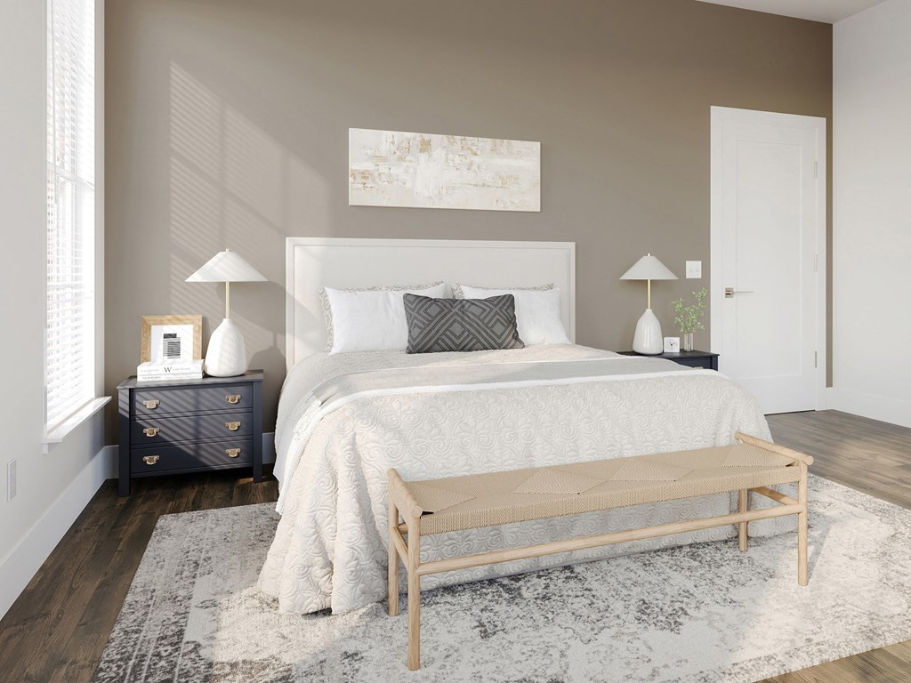 a bedroom with a white bed and a rug