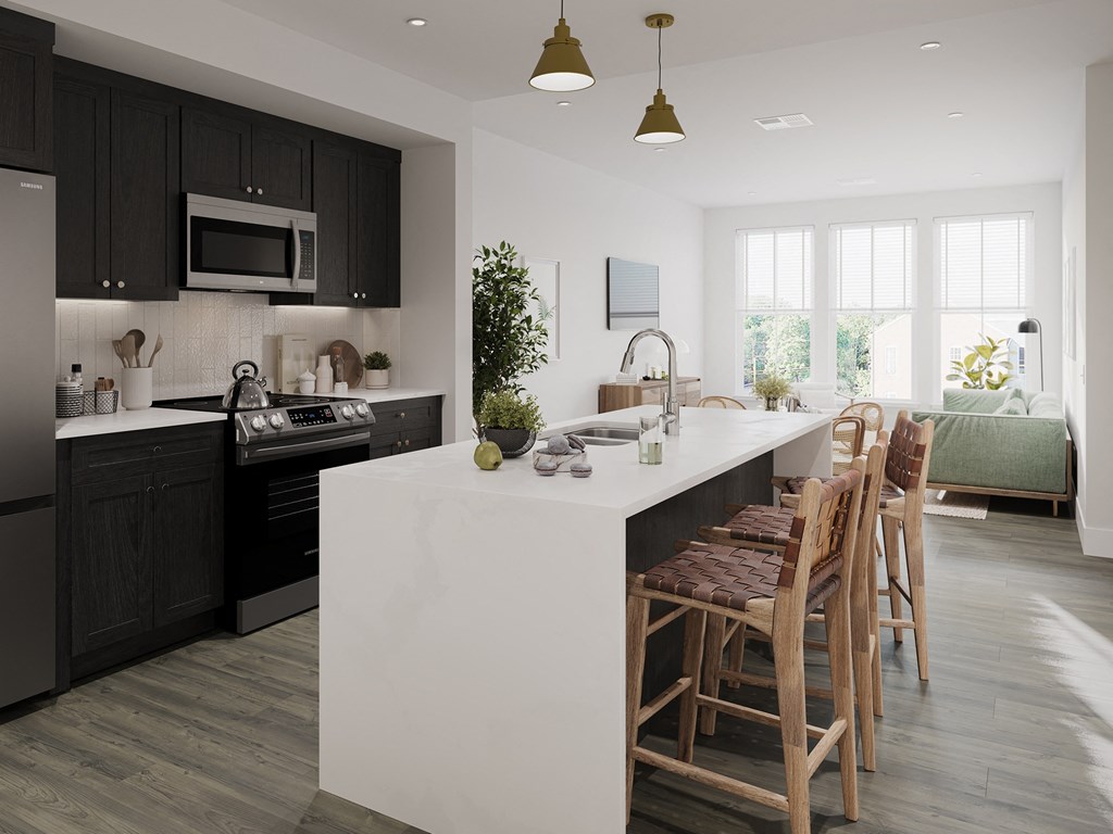a kitchen with black cabinets and a white island with chairs