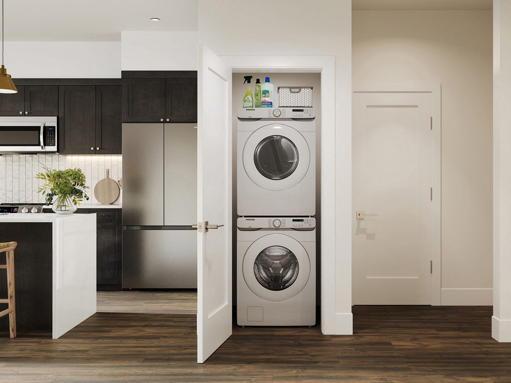a white front loading washer and dryer in a kitchen