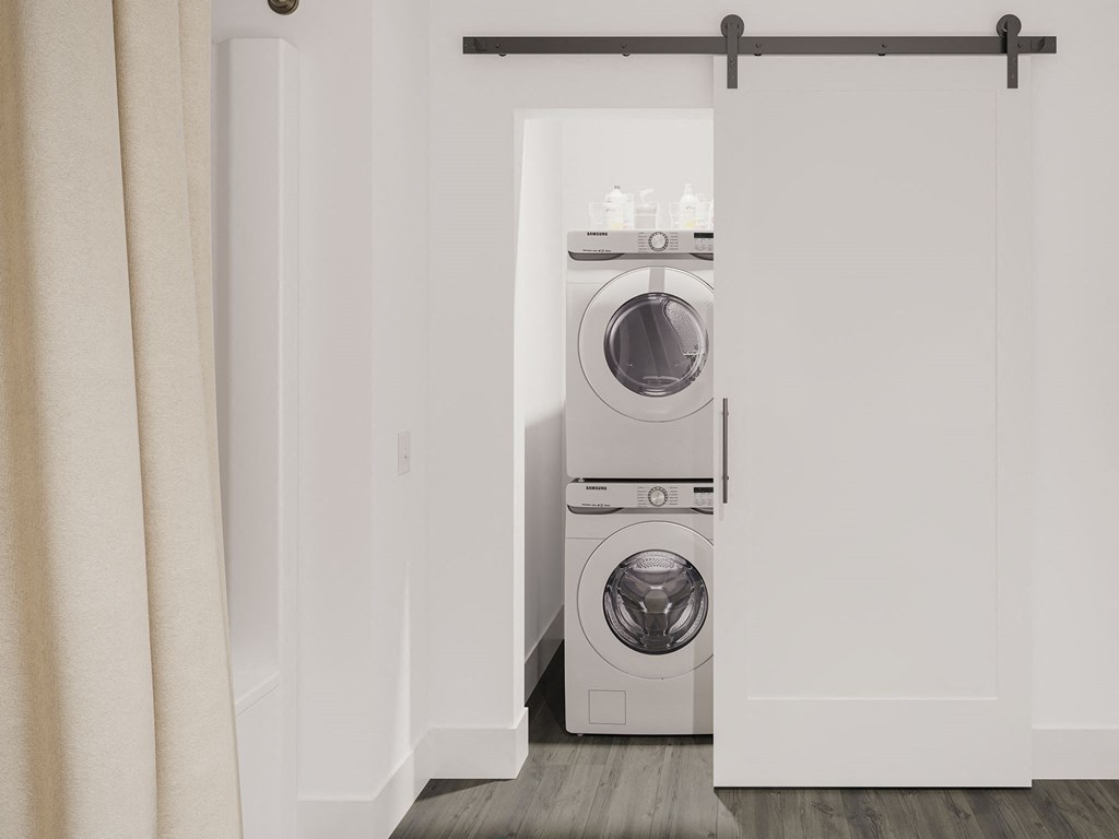 a white washer and dryer in a white closet