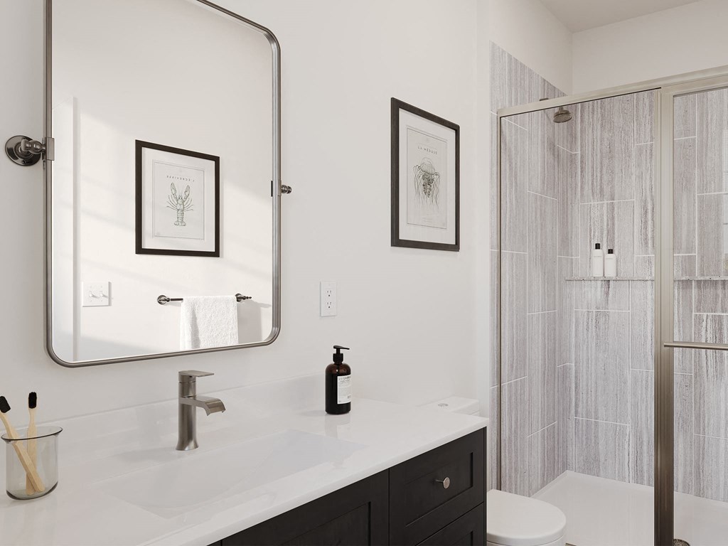 a bathroom with a shower and a sink and a mirror