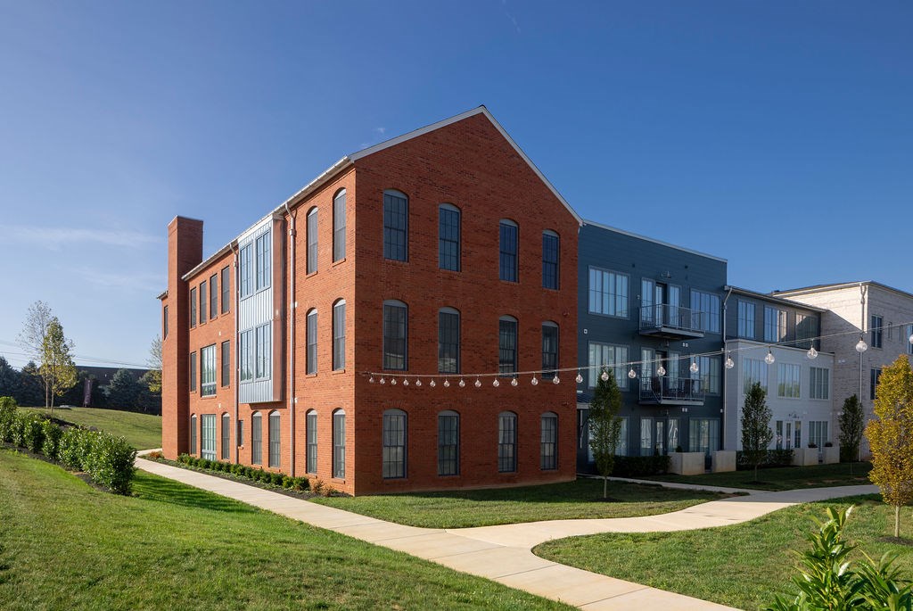 A red brick building with a walkway in front of it.