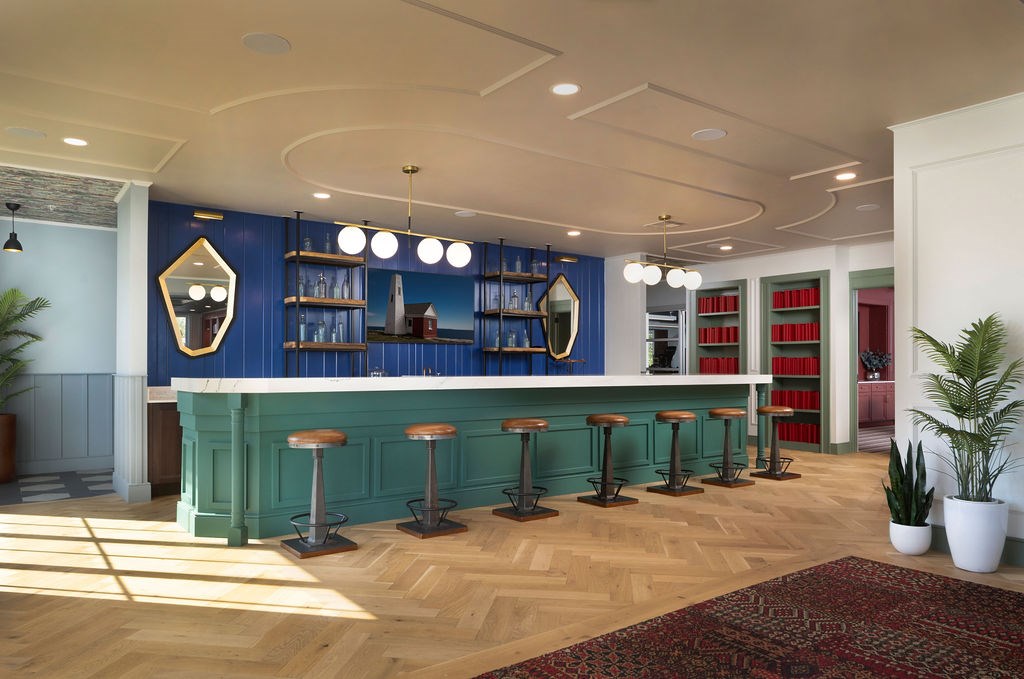 A bar with a green counter and stools is shown.