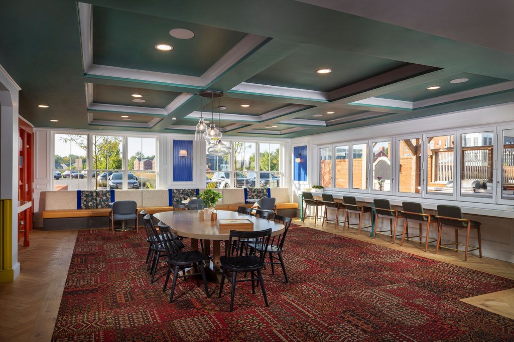 A large room with a long table and chairs.