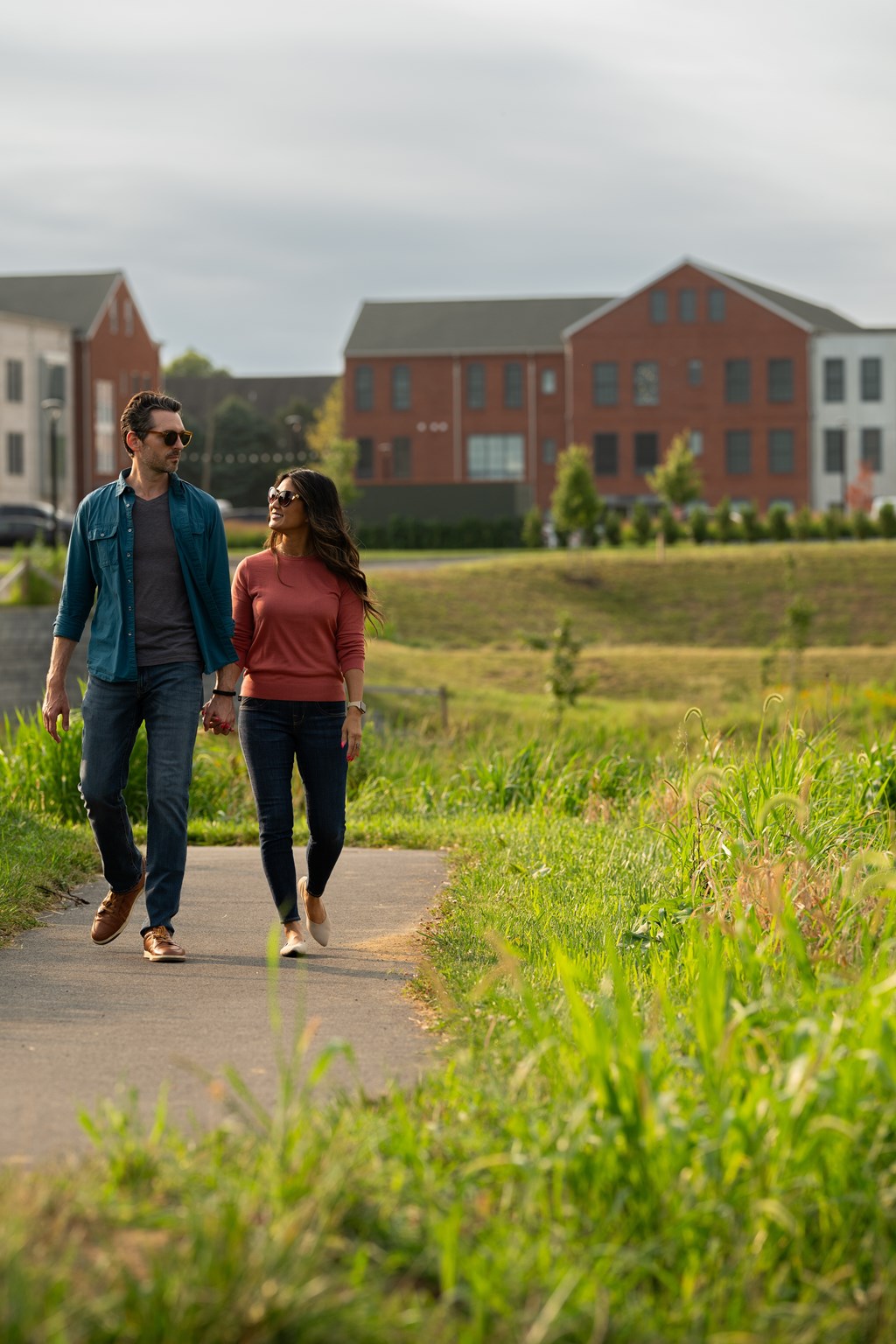 A man and a woman are walking on a path.