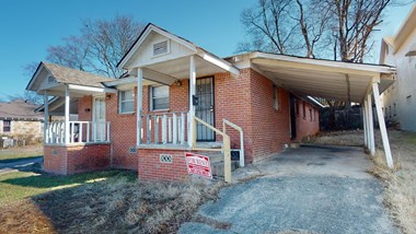 a house with a for sale sign in front of it
