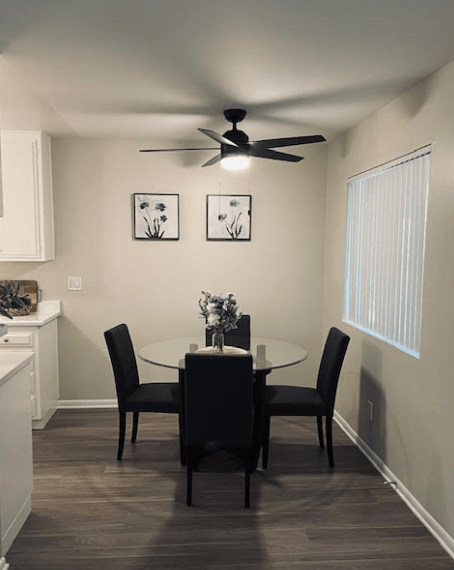 A dining room with a table set for two.