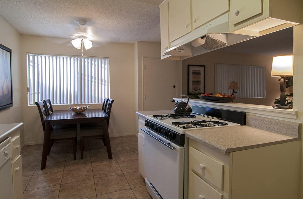 an open kitchen and dining room with a table and chairs