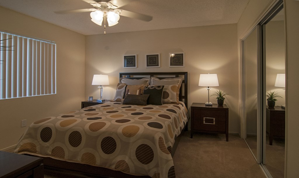 a bedroom with a bed and a ceiling fan