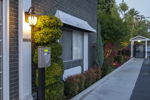 a mailbox on a sidewalk in front of a brick building
