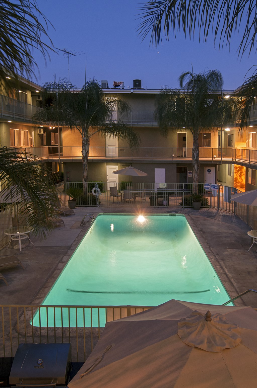 a view of the pool and poolside hot tub at night