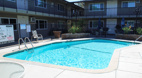 A small pool in front of apartment building.