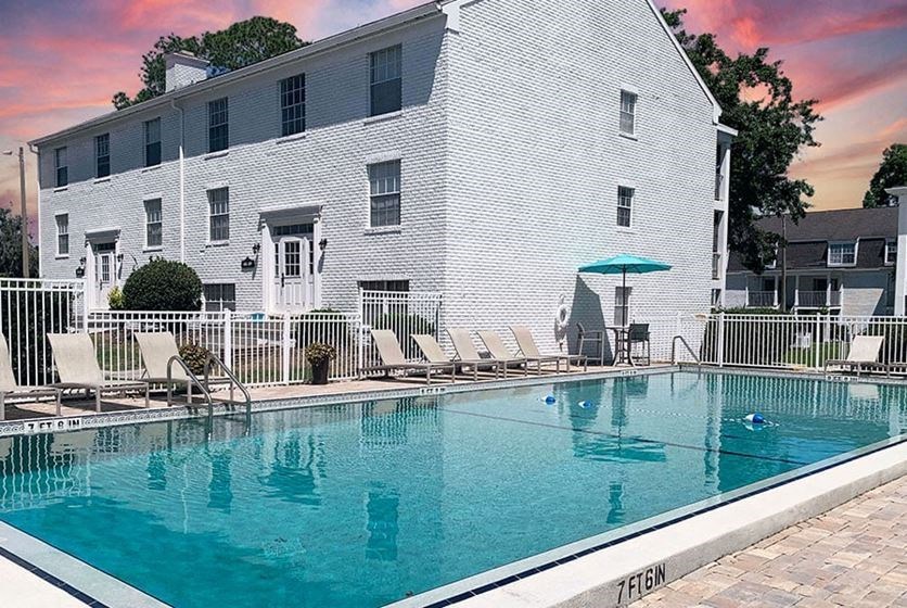 a large pool in front of a white building