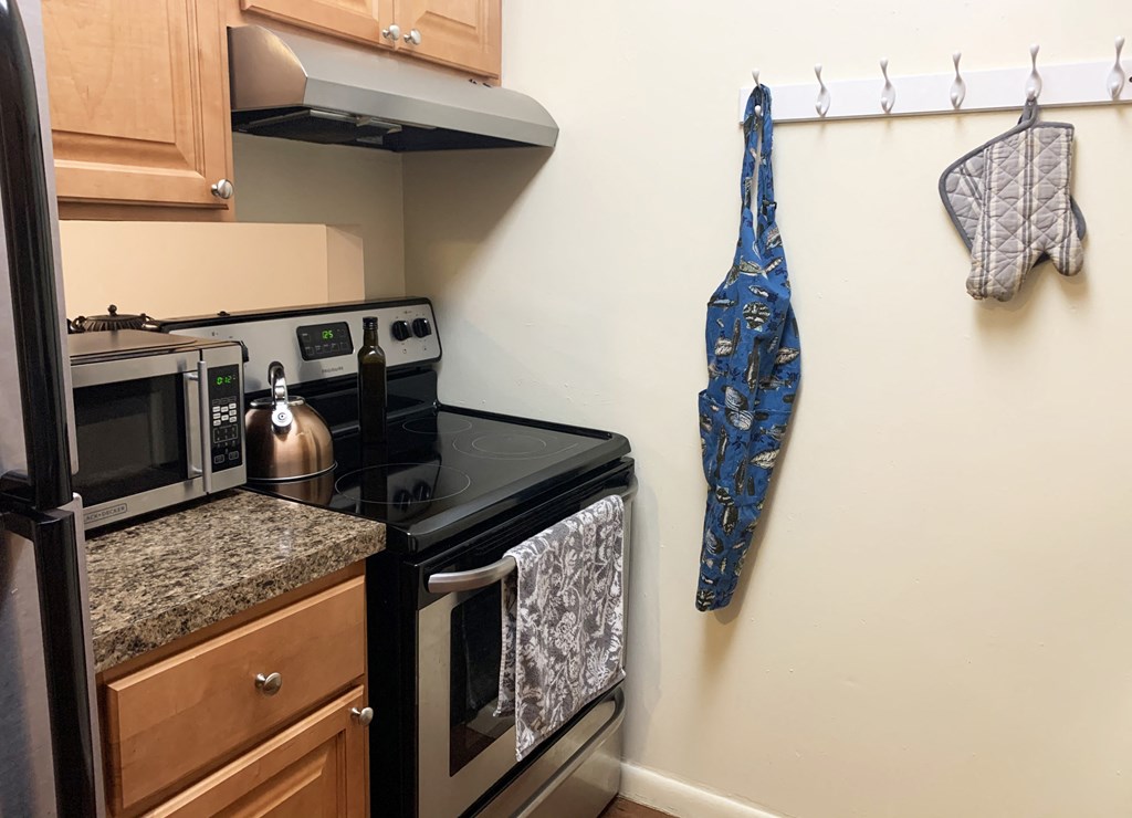 a kitchen with a stove top oven next to a refrigerator