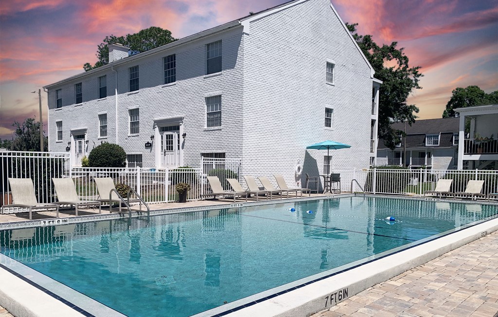 a white building with a large pool in front of it
