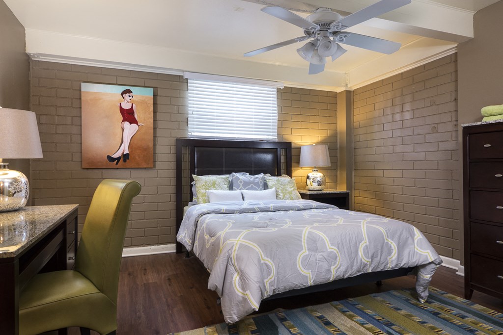 a bedroom with a bed and a desk