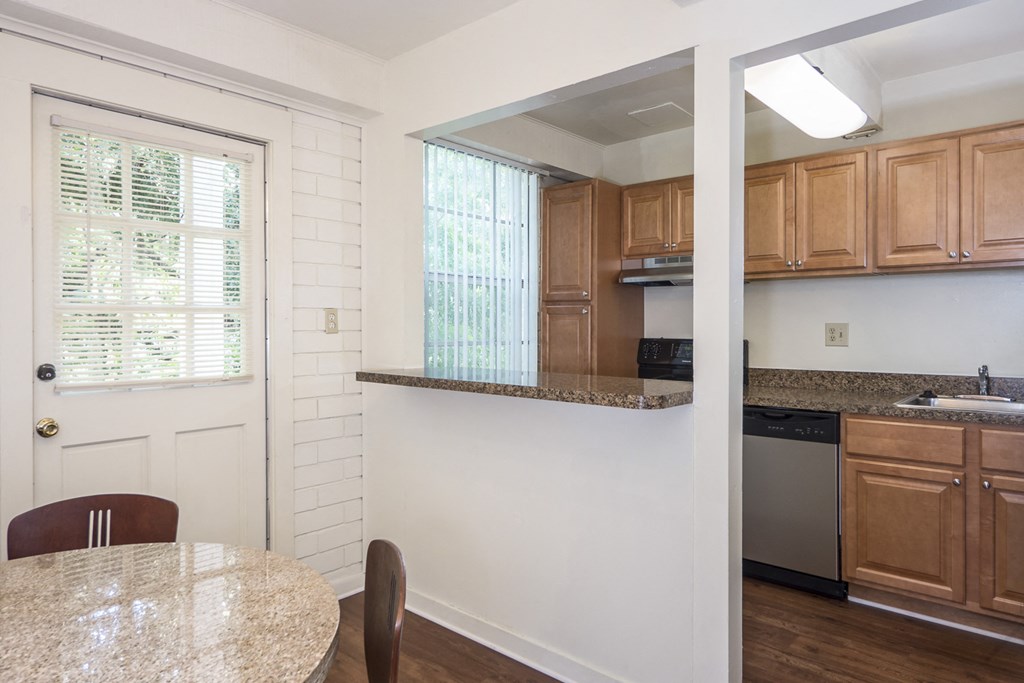 a kitchen with wood cabinets and a white door