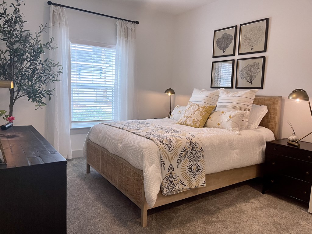 a bedroom with a bed and a dresser