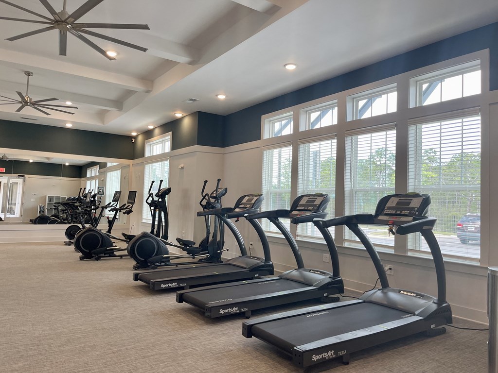 fitness center with treadmills, ellipticals and stationary bikes