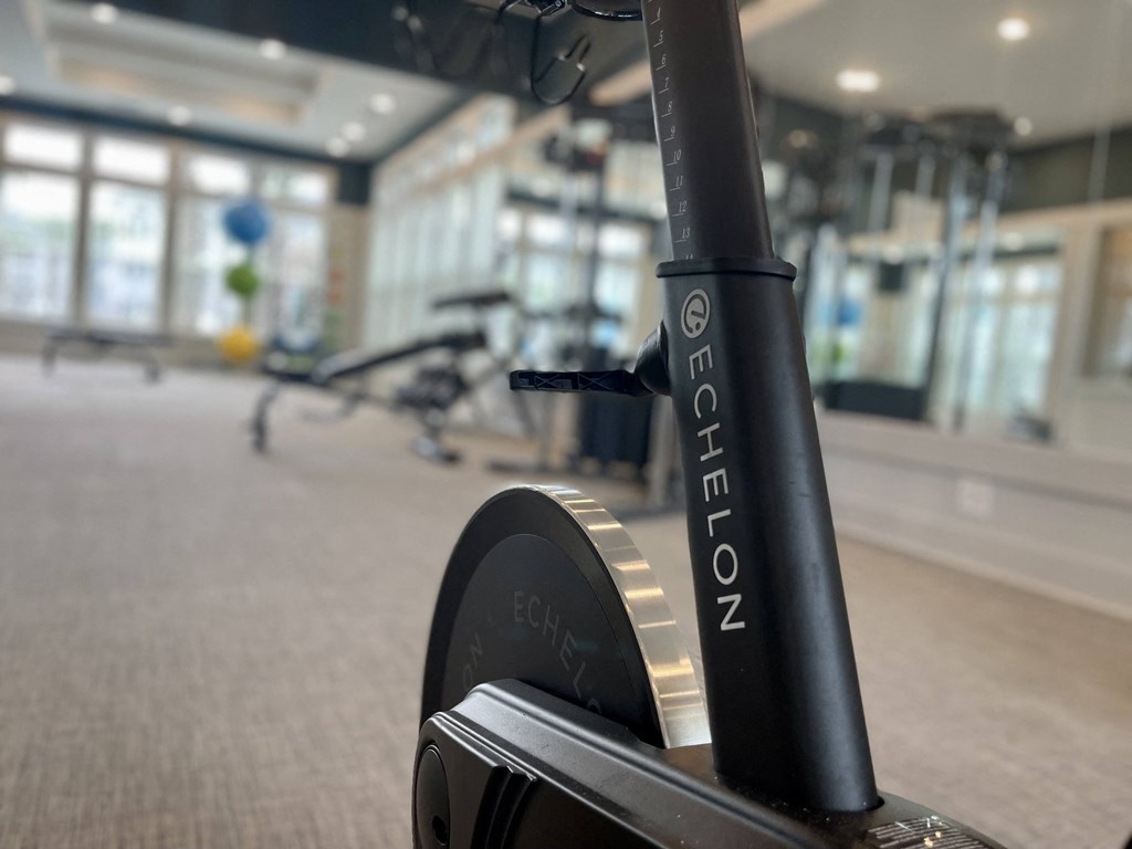 a bike in the gym at the district flats apartments in lenexa, ks