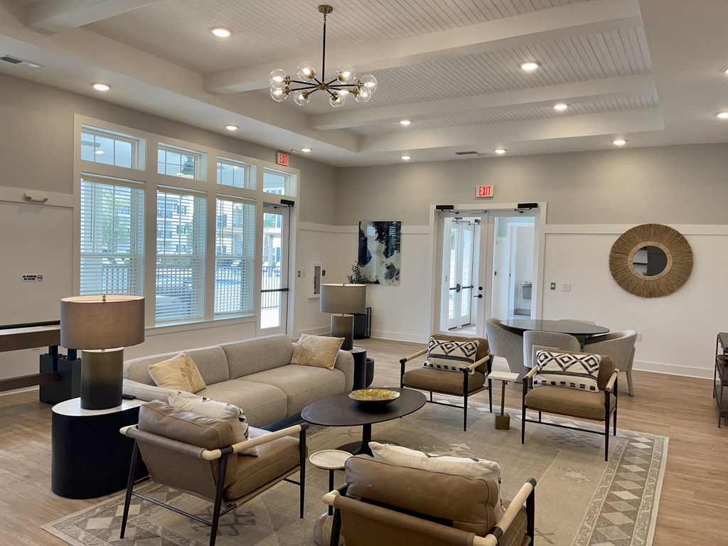 a resident clubhouse with couches chairs and a ping pong table