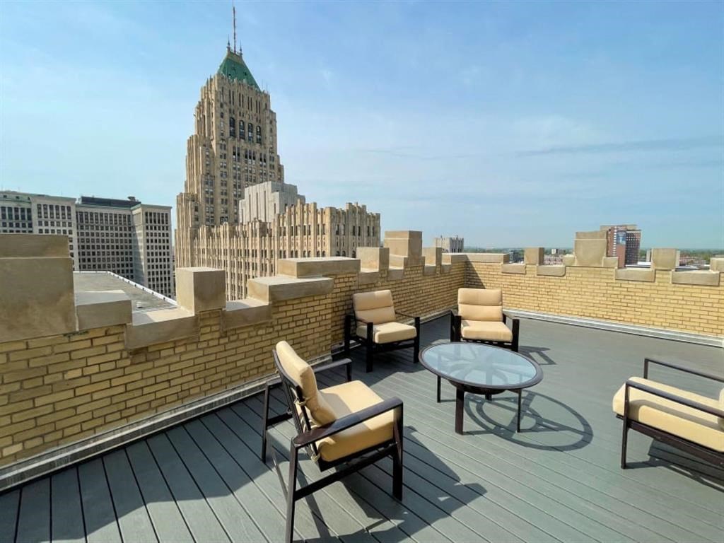 a rooftop terrace with a view of the city