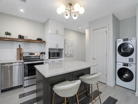 a kitchen with a counter top and a washing machine