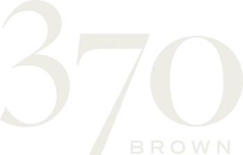 A green sign with the number 370 and the word Brown.