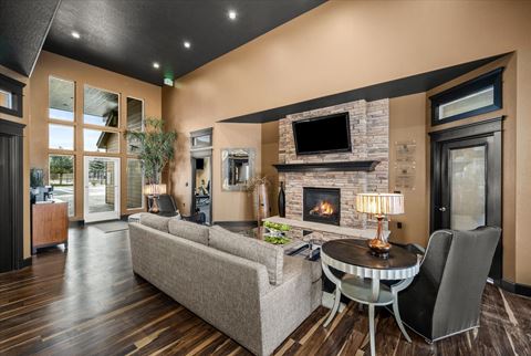 a living room with a fireplace and a table and chairs