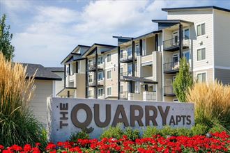 an apartment building with a sign that reads the quarry apts