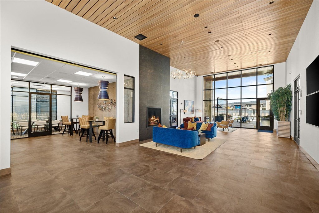 a large living room with a blue couch and a fireplace