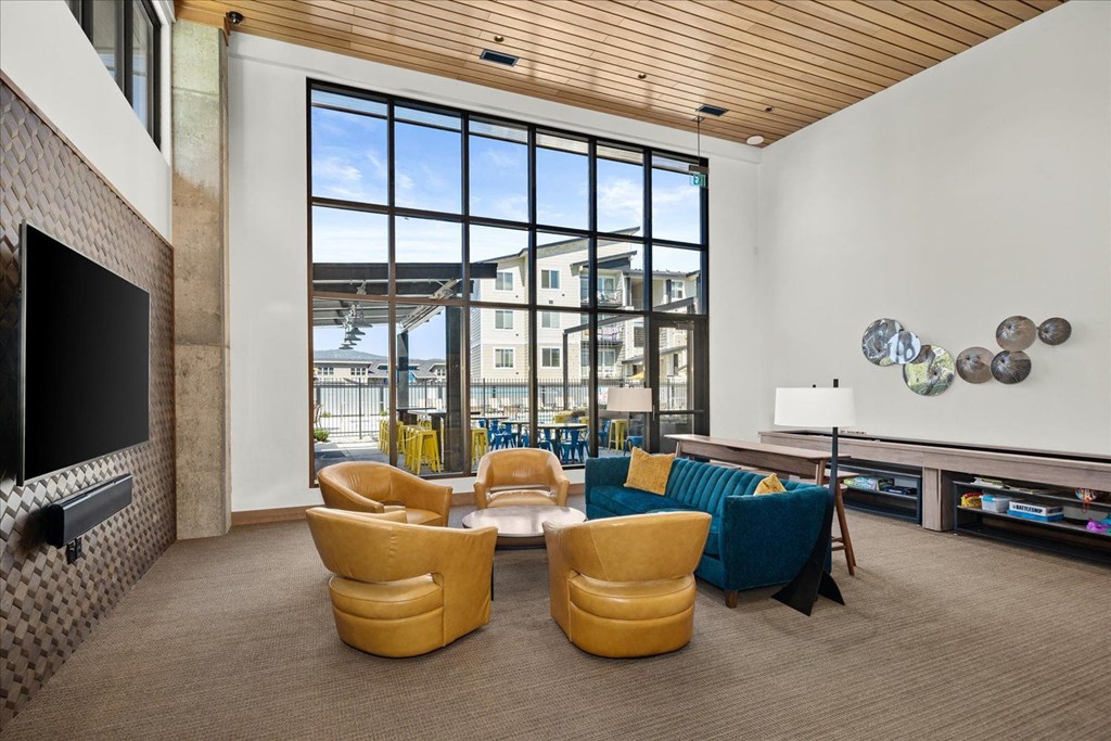 a living room with couches and chairs and a television