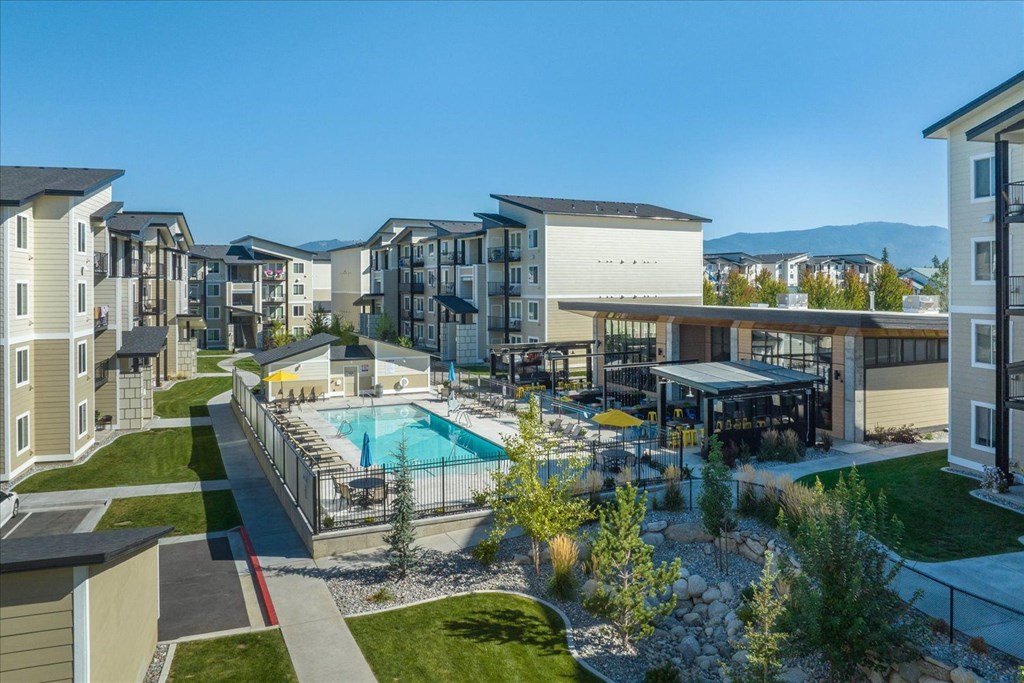an aerial view of an apartment complex with a swimming pool