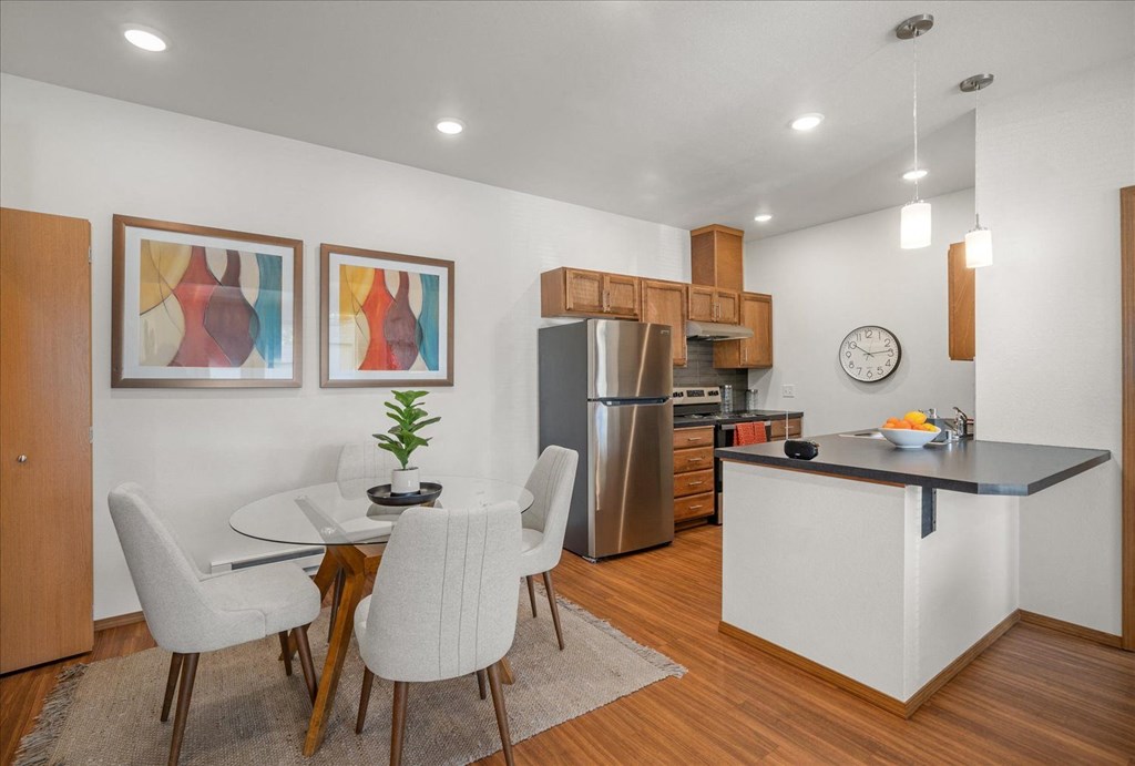a kitchen and dining room with a table and chairs