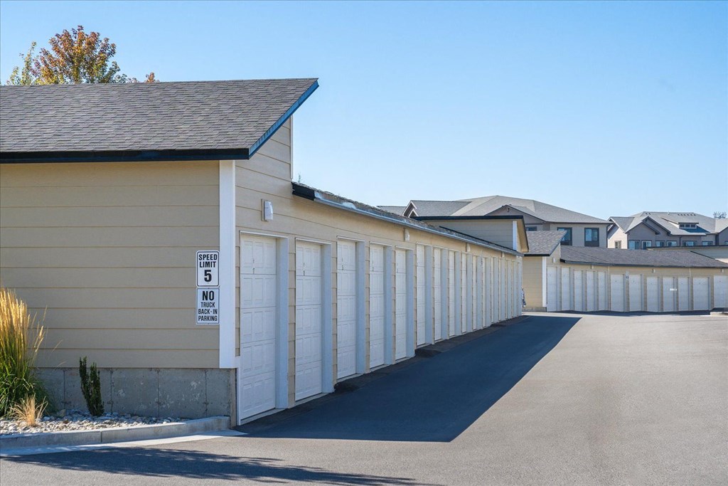 the side of a building with a row of garage doors