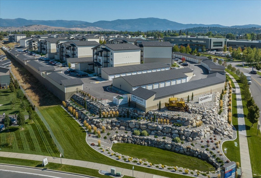 an aerial view of an industrial park with buildings and a field