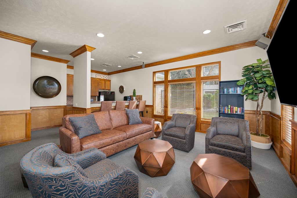 A living room with a brown couch and a blue chair.